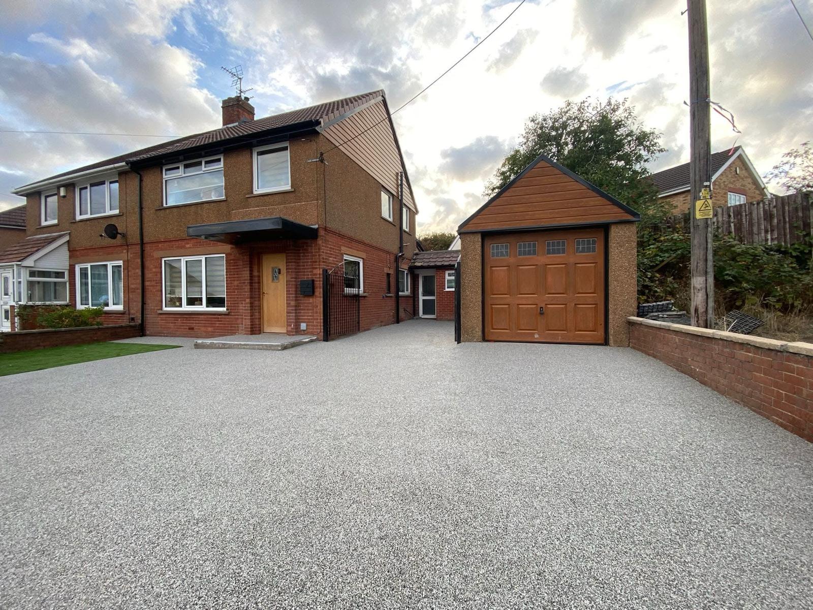 Smooth grey resin driveway with crisp edges after completion