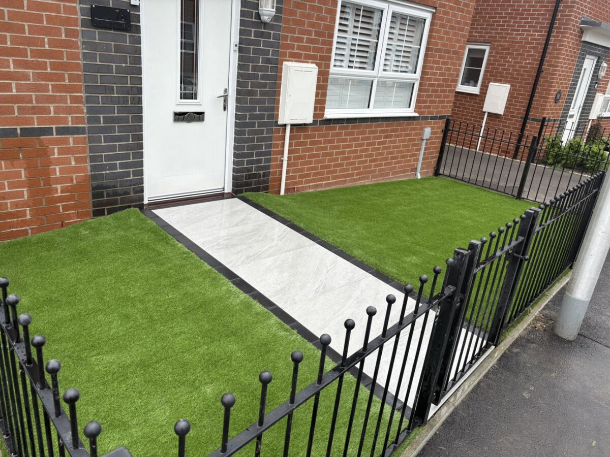 Finished garden in Bridgend with artificial grass and a tiled pathway